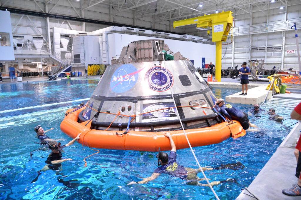 Divers train for Orion underway recovery in the Neutral Buoyancy Lab at NASA's Johnson Space Center in Houston.