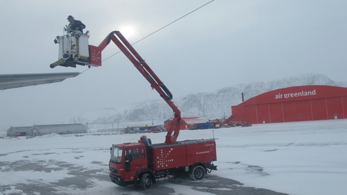 Deicing truck treating the P-3