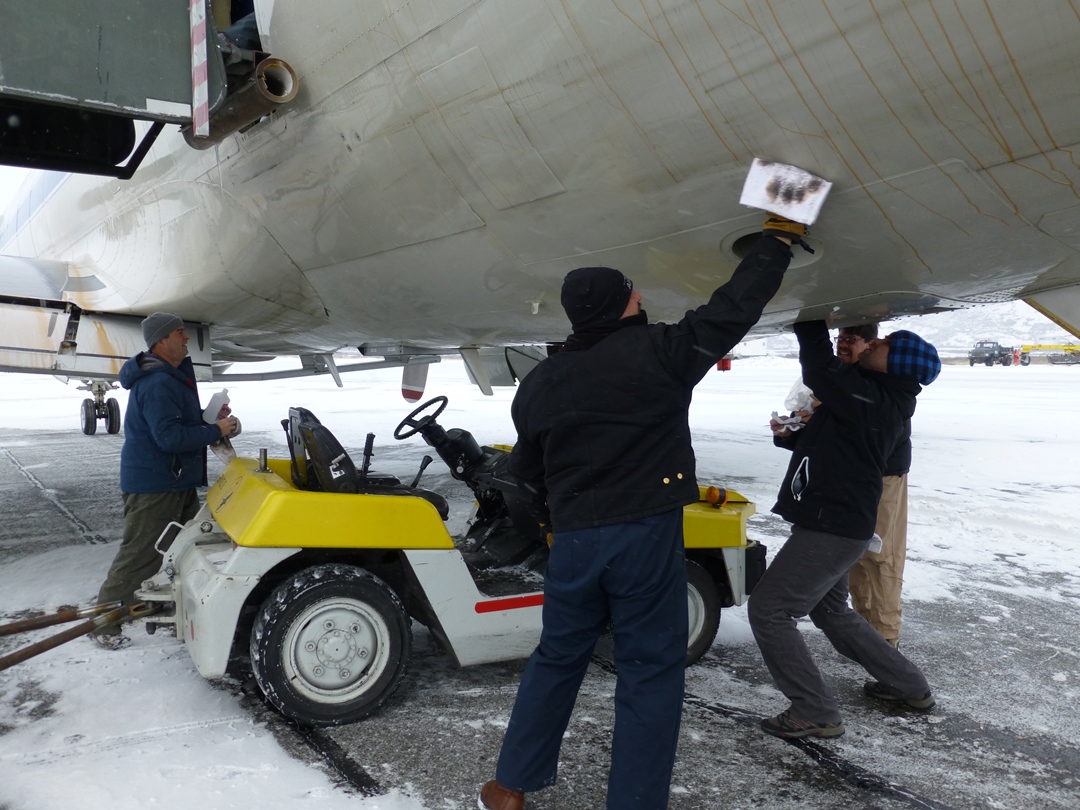 Team members clean the P-3