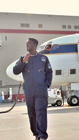 Albert Kodua posing in front of a NASA aircraft.