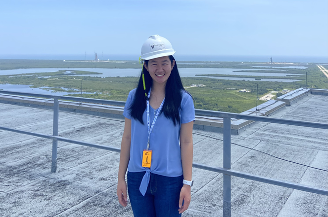 Yuhan Liu is standing on the roof of the Kennedy Space Center in Florida with her hard hat on.