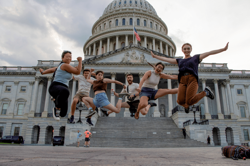 A fun image of interns jumping with joy in front of the U.S. Capitol. 