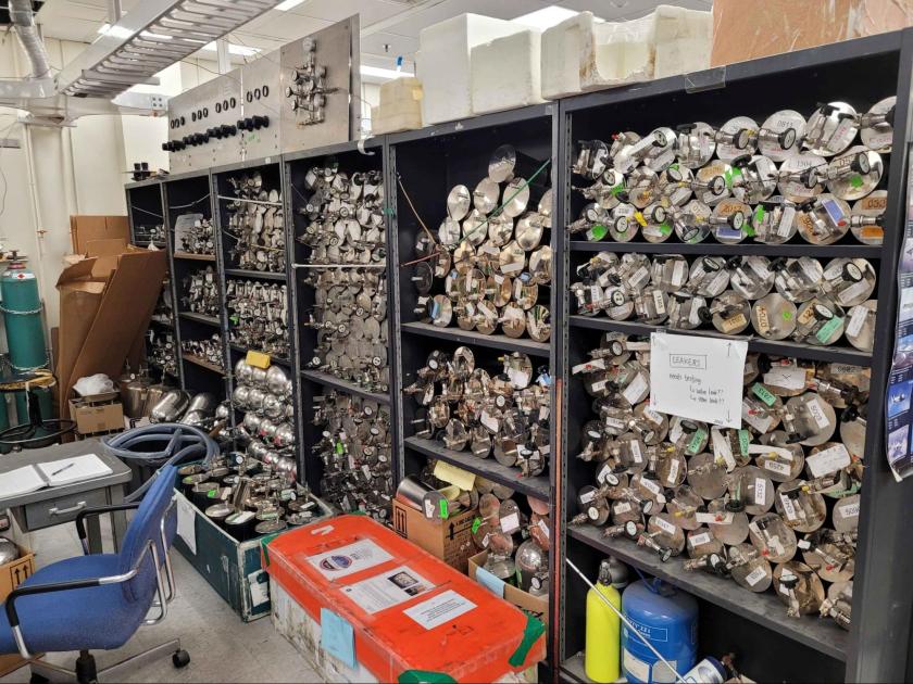 Air sample tubes sit stacked on top of each other in a large lab. 