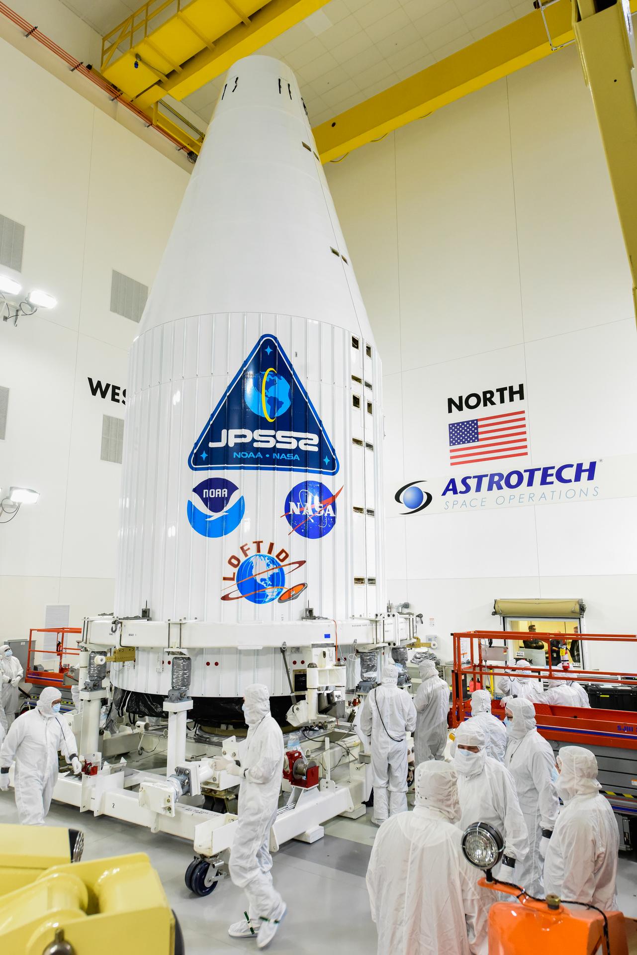 Technicians check the United Launch Alliance Atlas V payload fairing containing the National Oceanic and Atmospheric Administration’s (NOAA) Joint Polar Satellite System-2 (JPSS-2) inside the Astrotech Space Operations facility at Vandenberg Space Force Base (VSFB) in California on Oct. 12, 2022. 