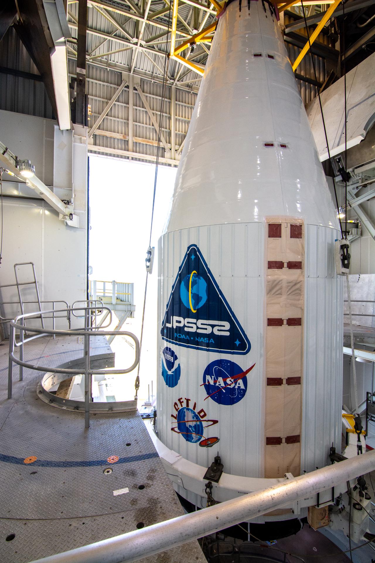 The United Launch Alliance Atlas V payload fairing containing the National Oceanic and Atmospheric Administration’s (NOAA) Joint Polar Satellite System-2 (JPSS-2) arrives inside the vertical integration facility at Space Launch Complex 3 at Vandenberg Space Force Base (VSFB) in California on Oct. 18, 2022. Inside the fairing, JPSS-2 is stacked atop NASA’s Low-Earth Orbit Flight Test of an Inflatable Decelerator (LOFTID) secondary payload.