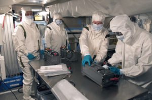 Technicians and engineers prepare a P-POD container for installation on the Delta II rocket launching JPSS-1.