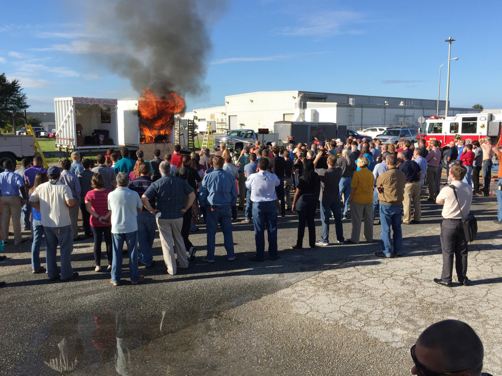 NASA Kennedy Space Center employees observed a fire safety demonstration Oct. 8  presented by the Florida Fire Sprinkler Association during the National Fire Protection Association's Fire Prevention Week. Kennedy Space Center firefighters were on hand to extinguish the fire. Photo credit: NASA/Greg Harland