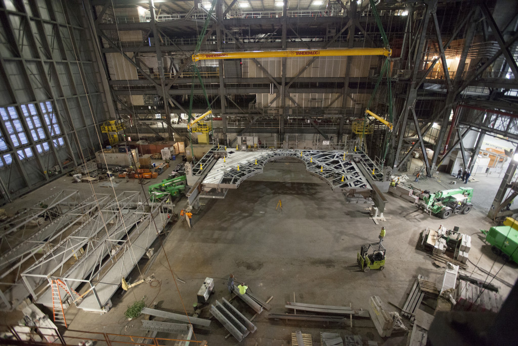 A 325-ton crane has lowered the first half of the K-level work platforms into High Bay 3 of the Vehicle Assembly Building at NASA's Kennedy Space Center in Florida. The platform will be secured into position on tower E, about 86 feet above the floor. The K work platforms will provide access to NASA's Space Launch System (SLS) core stage and solid rocket boosters during processing and stacking operations on the mobile launcher.  Photo credit: NASA/Ben Smegelsky