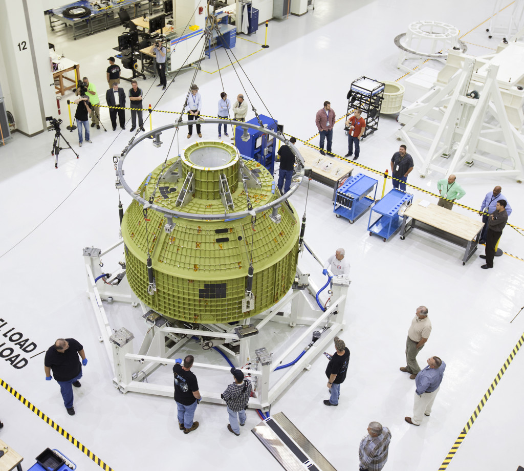 The Orion crew module pressure vessel is secured on a birdcage test stand in the Operations and Checkout Building at Kennedy Space Center.