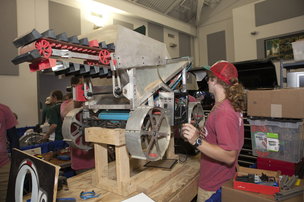 A participant in NASA's 7th annual Robotic Mining Competition uncrates a robotic excavator as his team prepares for practice runs and competition.