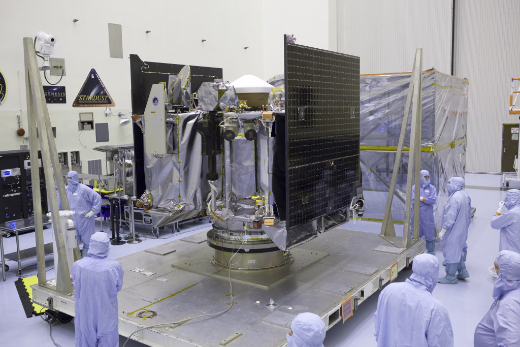 NASA's OSIRIS-REx spacecraft is revealed after its protective cover is removed inside the Payload Hazardous Servicing Facility at Kennedy Space Center in Florida.