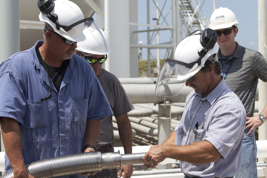 Engineers and technicians go over procedures with liquid hydrogen (LH2) provider PRAXAIR April 28 to prepare for a fit check of the new LH2 transfer flex hose at Launch Pad 39B