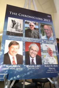 A poster in the NASA News Center at Kennedy Space Center in Florida bears the names and photos of the six new honorees added to the facility's "Chroniclers" roll of honor. 