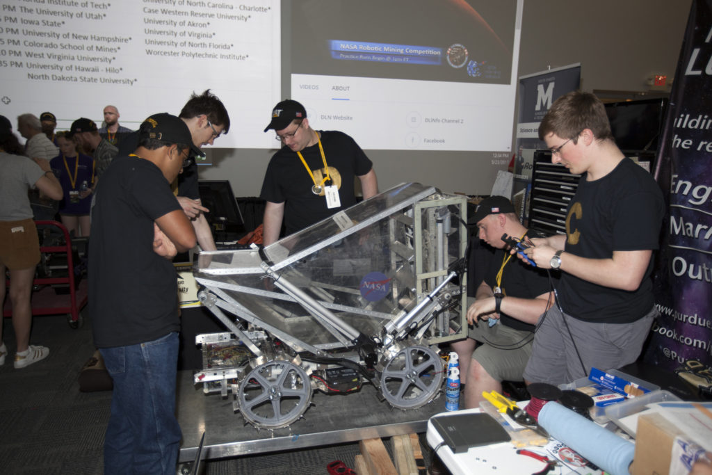 Team members from Purdue University prepare their robot miner in the RoboPit at NASA's 8th Annual Robotic Mining Competition at the Kennedy Space Center Visitor Complex in Florida.