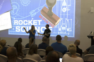 Education Specialists Lynn Dotson, left, of the NASA Public Engagement Center, and Lester Morales, right, of Texas State University's NASA STEM Educator Professional Development Collaborative, explain the Rocketry Engineering Design Challenge to teachers participating in the 2017 GE Foundation High School STEM Integration Conference at the Center for Space Education at NASA's Kennedy Space Center. 