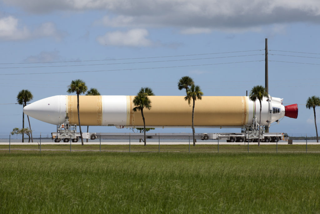 Framed by a series of cabbage palms, a United Launch Alliance Delta IV Heavy common booster core is transported by truck to Cape Canaveral Air Force Station's Launch Complex 37 Horizontal Processing Facility after arriving at Port Canaveral. The Delta IV Heavy will launch NASA's upcoming Parker Solar Probe mission. The mission will perform the closest-ever observations of a star when it travels through the Sun's atmosphere, called the corona. The probe will rely on measurements and imaging to revolutionize our understanding of the corona and the Sun-Earth connection. Liftoff atop the Delta IV Heavy rocket is scheduled to take place from Cape Canaveral's Space Launch Complex 37 in summer 2018.