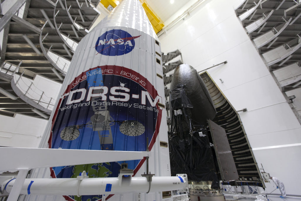 Inside the Astrotech facility in Titusville, Florida, the payload fairing for NASA's Tracking and Data Relay Satellite, TDRS-M, is moved into position to encapsulate the spacecraft. Photo credit: NASA/Kim Shiflett