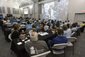 Students and sponsors hear from astronauts aboard the International Space Station on a big screen in the Center for Space Education at NASA’s Kennedy Space Center in Florida.