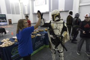 A middle-school student high-fives a Star Wars character from the 501st Legion in the Center for Space Education at NASA’s Kennedy Space Center in Florida.