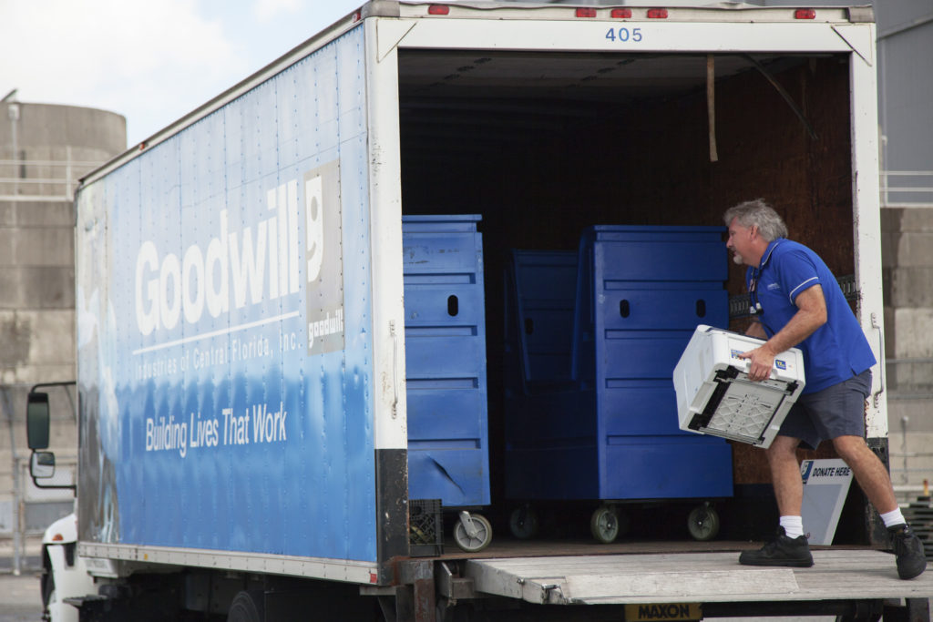 In the parking lot of the Vehicle Assembly Building at NASA's Kennedy Space Center, a member of Goodwill Industries loads used household material for recycling. During the two-day event, employees dropped off items as part of America Recycles Day. Photo credit: NASA/ Michelle Stone