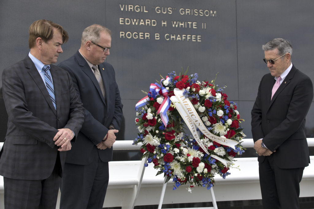 During the 2018 Day of Remembrance at NASA's Kennedy Space Center, from left, State Sen. Thad Altman, president and CEO of the Astronauts Memorial Foundation, Therrin Protze, chief operating officer of Delaware North, and Center Director Bob Cabana place a wreath at the Space Mirror Memorial. 