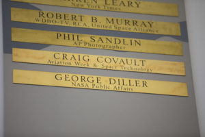 Brass strips engraved with the names of Craig Covault and George Diller were unveiled during a ceremony at Kennedy Space Center’s NASA News Center in Florida on Friday, May 4. 