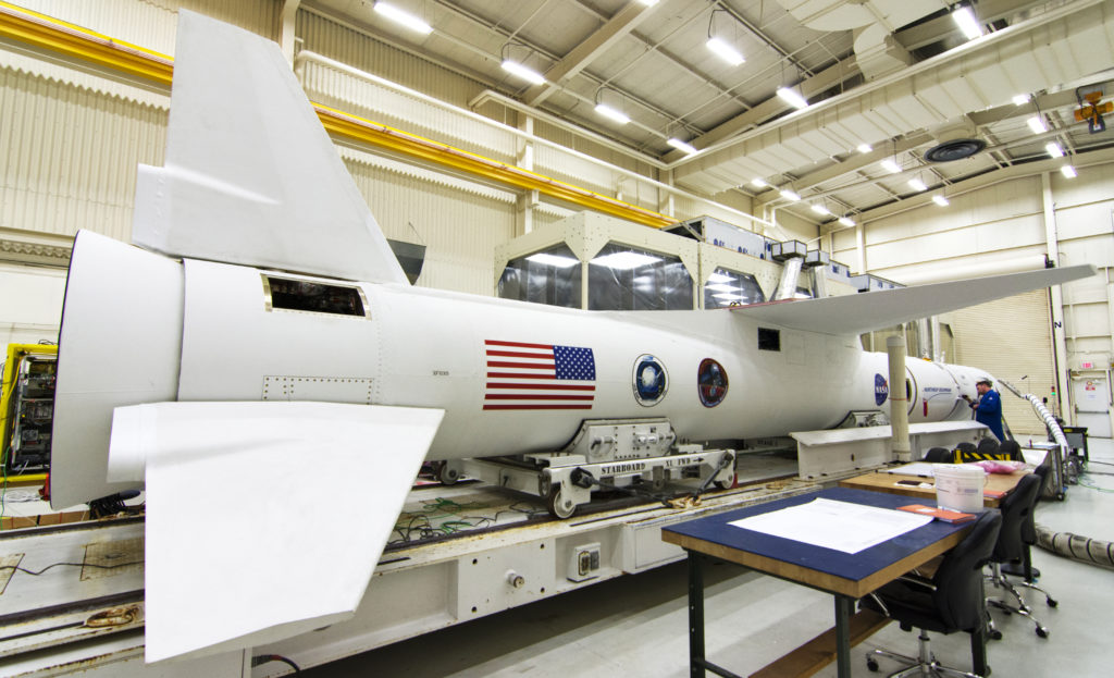 In Building 1555 at Vandenberg Air Force Base in California, preflight processing nears completion for a Northrup Grumman Pegasus XL rocket on Oct. 8, 2018. Enclosed in the rocket's payload fairing is NASA's Ionospheric Connection Explorer, or ICON, satellite.  Photo credit: NASA/Randy Beaudoin