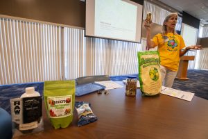 Sally Scalera, urban horticulture agent and master gardener coordinator from the University of Florida’s Institute of Food and Agricultural Sciences Brevard Extension Office, shows Kennedy Space Center employees some sustainable yard products available during her presentation on tips and tricks for a healthy yard and garden on April 24, 2019. Photo credit: NASA/Cory Huston