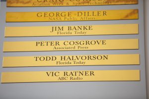 Brass strips engraved with the names of Jim Banke, Peter Cosgrove, Todd Halvorson and Vic Ratner were unveiled during a ceremony on May 3, 2019, at Kennedy Space Center’s NASA News Center in Florida. Banke, Halvorson, Ratner and Cosgrove were honored as members of The Chroniclers, which recognizes retirees of the news and communications business who have helped spread news of American space exploration from Kennedy for 10 years or more.