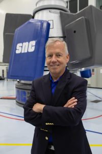 Steve Lindsey in front of Sierra Nevada Corporation's Shooting Star cargo module