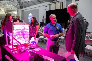 Trent Smith, left, NASA Veggie project manager at Kennedy Space Center, talks to an attendee about the Veggie plant growth system that is currently in use on the International Space Station, during a Community Leaders Update on Feb. 18, 2020, at the Kennedy Space Center Visitor Complex in Florida. 