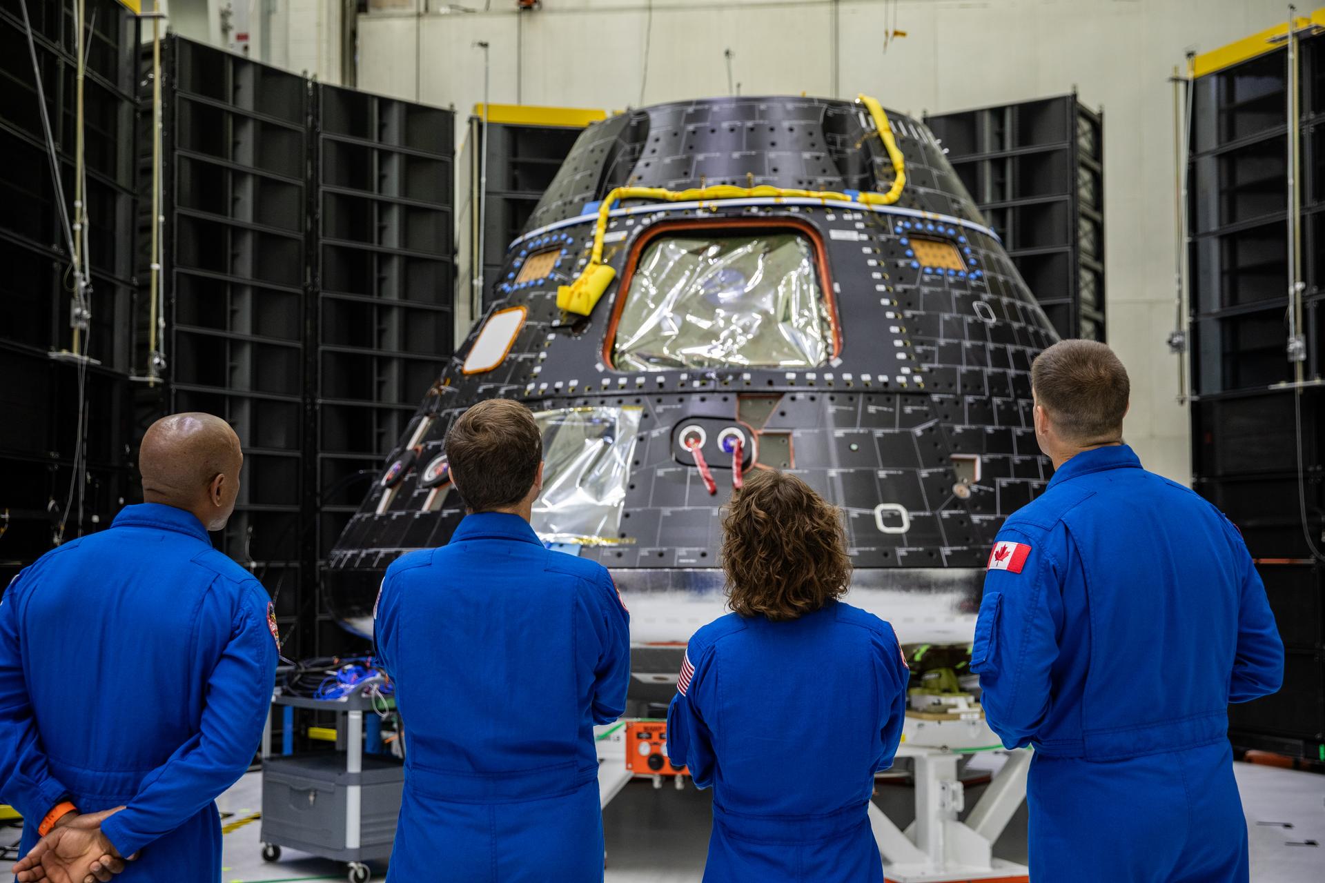 Artemis II crew members, shown inside the Neil Armstrong Operations and Checkout Building at NASA’s Kennedy Space Center in Florida, check out their Orion crew module on Aug. 8, 2023. From left are: Victor Glover, pilot; Reid Wiseman, commander; Christina Hammock Koch, mission specialist; and Jeremy Hansen, mission specialist. The crew module is undergoing acoustic testing ahead of integration with the European Service Module. Artemis II is the first crewed mission on NASA’s path to establishing a long-term lunar presence for science and exploration under Artemis. 