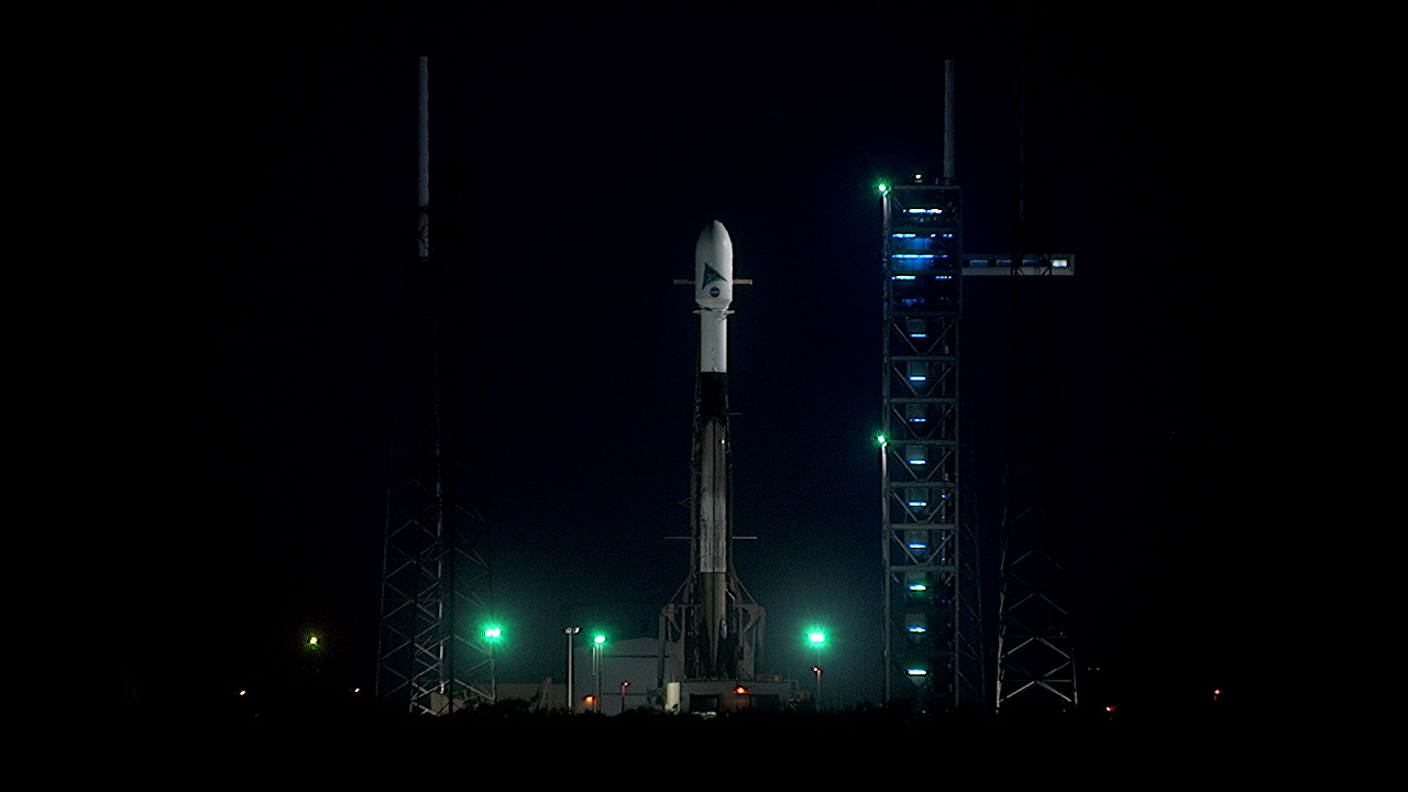 A SpaceX Falcon 9 rocket topped with NASA's PACE (Plankton, Aerosol, Cloud, ocean Ecosystem) spacecraft inside a protective payload fairing is raised vertical at Space Launch Complex 40 at Cape Canaveral Space Force Station in Florida.