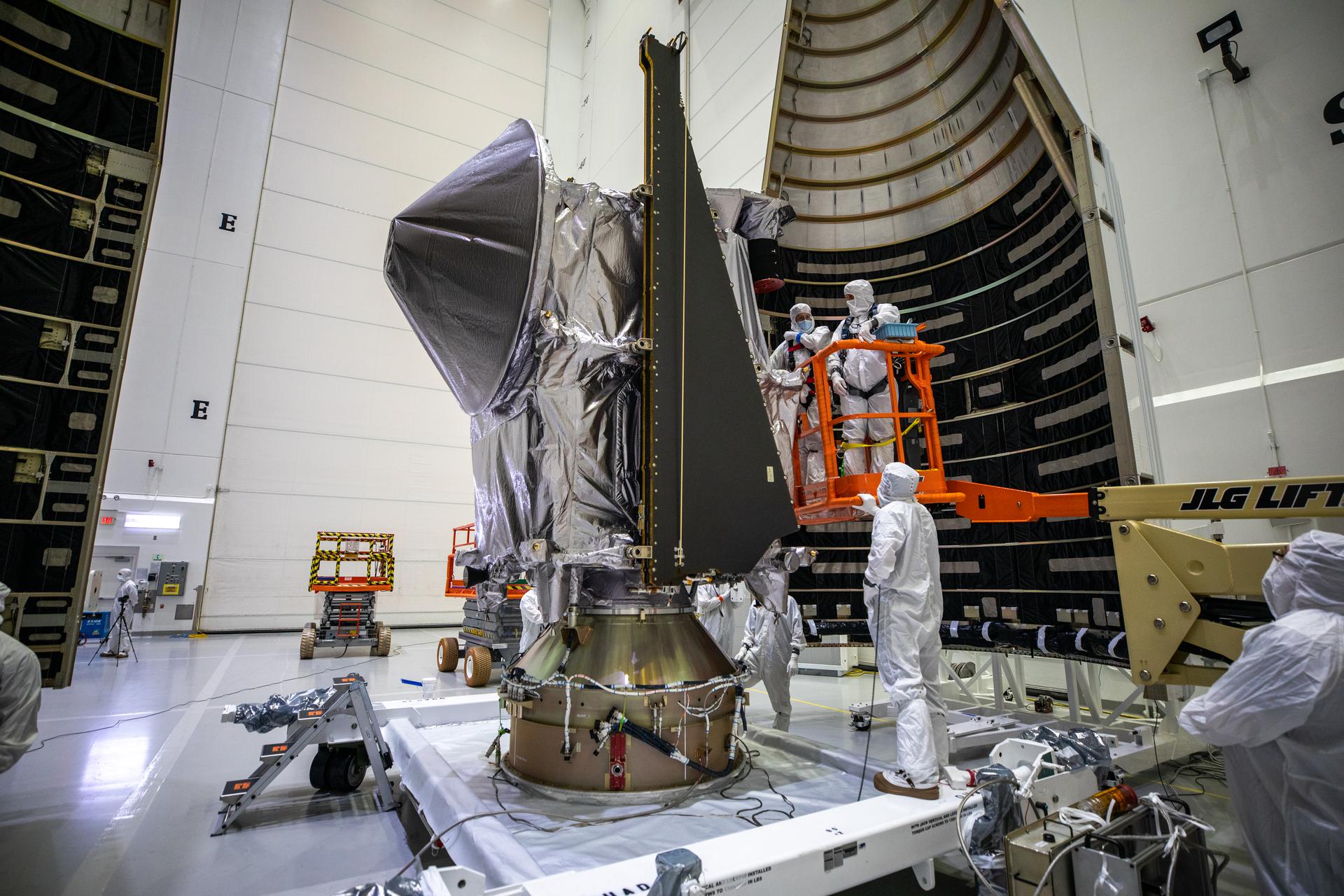 Workers inside the Astrotech Space Operations Facility in Titusville, Florida, move the first half of the United Launch Alliance (ULA) payload fairing toward NASA’s Lucy spacecraft on Sept. 30, 2021. 