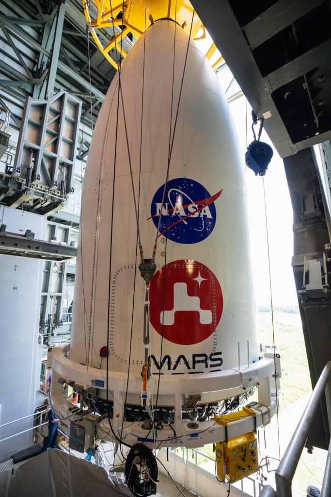 The United Launch Alliance (ULA) payload fairing with NASA’s Mars 2020 Perseverance rover secured inside is positioned on top of the ULA Atlas V rocket inside the Vertical Integration Facility (VIF) at Space Launch Complex 41 at Cape Canaveral Air Force Station in Florida on July 7, 2020.