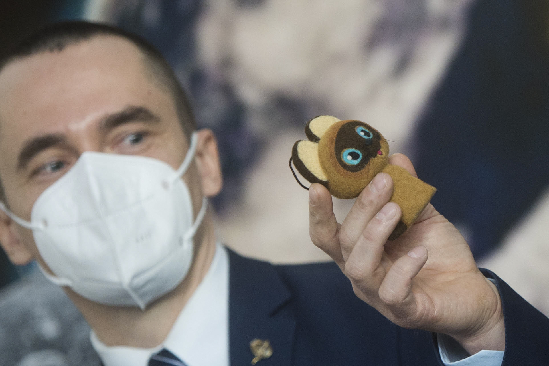 Expedition 65 prime crew member Oleg Novitskiy of Roscosmos, holds up a toy cat that will be used in the Soyuz capsule to help indicate the start of weightlessness after leaving the Earth’s atmosphere.