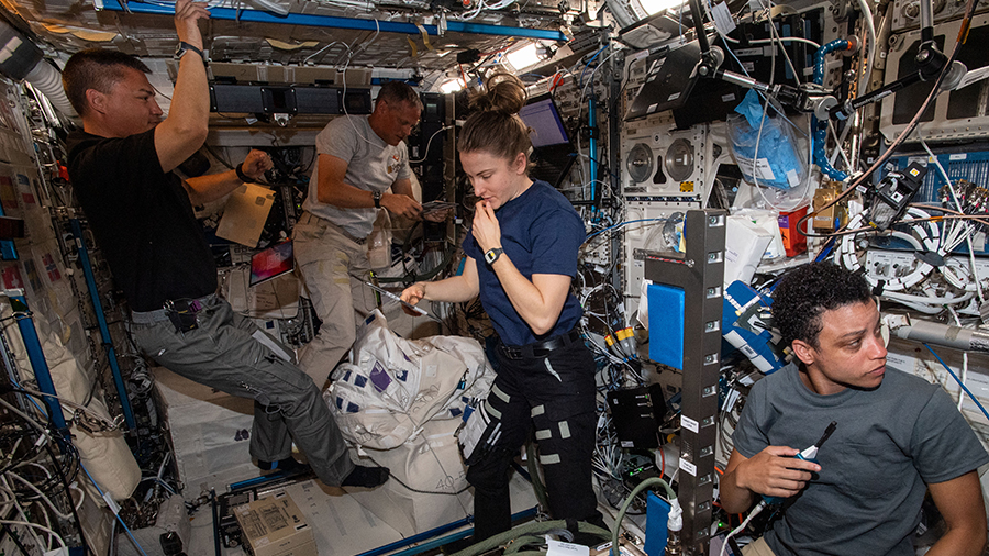 NASA astronauts (from left) Kjell Lindgren, Bob Hines, Kayla Barron, and Jessica Watkins work inside the Columbus laboratory module on May 2, 2022.