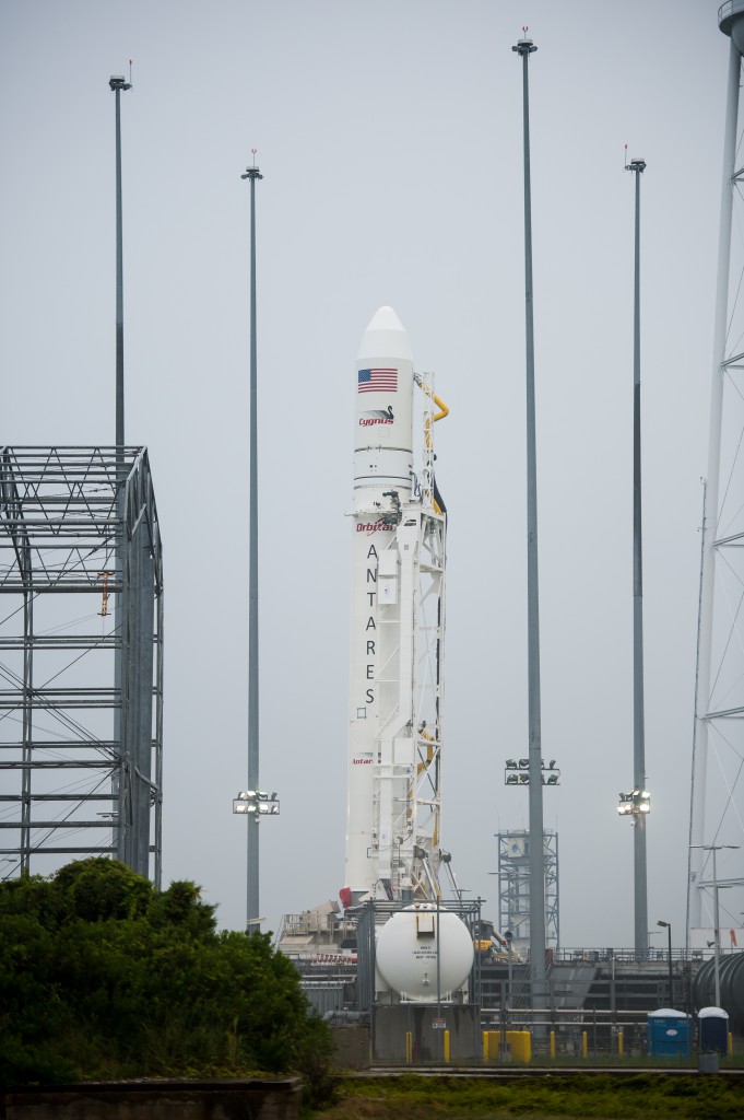 The Orbital Sciences Corporation Antares rocket, with the Cygnus spacecraft aboard, stands vertically at Launch Pad-0A after successfully being raised into position Thursday, July 10, 2014, at NASA's Wallops Flight Facility in Virginia. Credit: NASA/Aubrey Gemignani