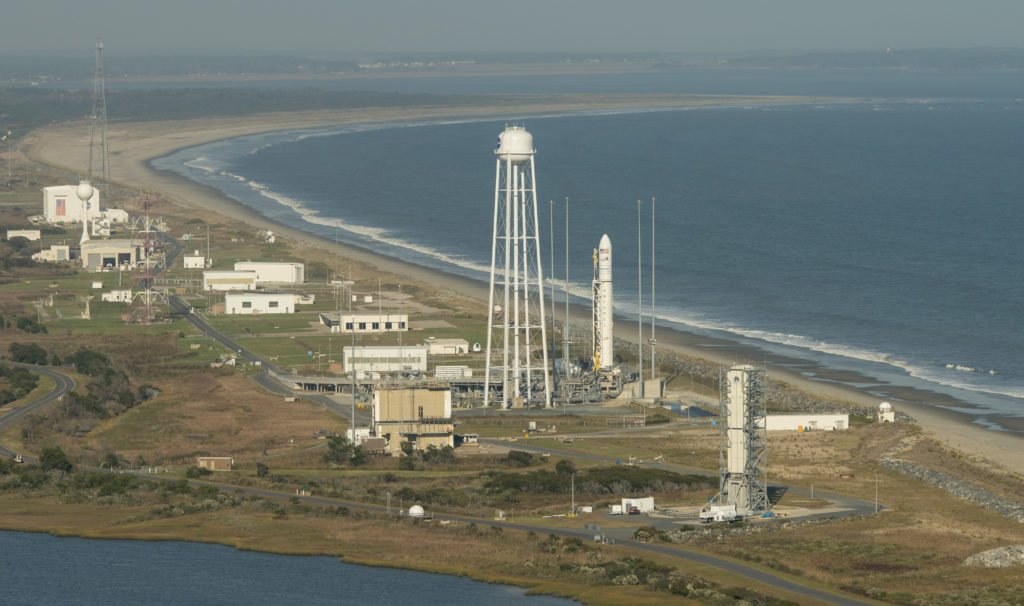 Aerial photograph showing the Orbital ATK Antares rocket, with the Cygnus spacecraft onboard, on launch Pad-0A, Monday, Oct. 17, 2016 at NASA's Wallops Flight Facility in Virginia. Orbital ATK’s sixth contracted cargo resupply mission with NASA to the International Space Station will deliver over 5,100 pounds of science and research, crew supplies and vehicle hardware to the orbital laboratory and its crew. Photo Credit: (NASA/Bill Ingalls)