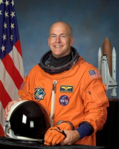 astronaut in orange suit with helmet