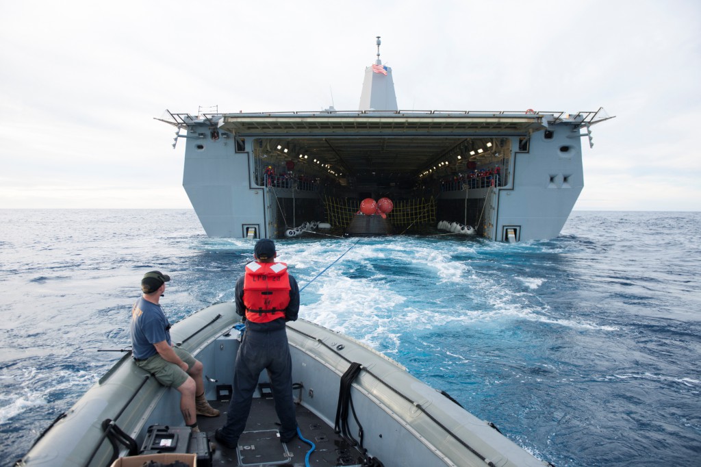 The Orion spacecraft is guided into the well deck of the USS Anchorage during recovery operations following splashdown. Photo credit: NASA