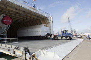 The Port Common Booster Core of the Delta IV Heavy for the Parker Solar Probe (PSP) Mission is offloaded from the Mariner and transported to the Horizontal Integration Facility.