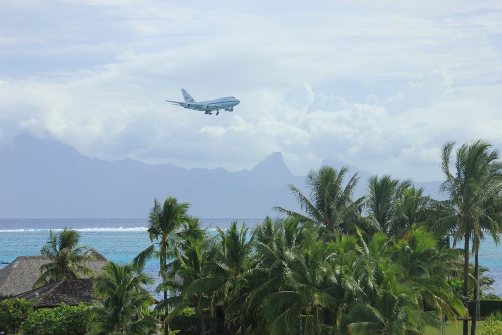 SOFIA landing in French Polynesia with mountains in the background and tropical trees in the foreground