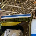 The SOFIA team begins lifting the upper rigid door off the aircraft.