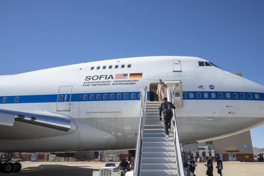 SOFIA is seen in front of Building 703 with crew going down the stairs