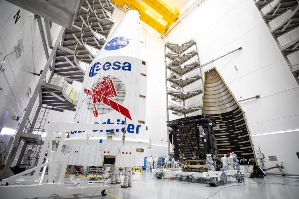 Both halves of a United Launch Alliance Atlas V payload fairing are positioned for installation around the Solar Orbiter spacecraft inside the Astrotech Space Operations facility in Titusville, Florida, on Jan. 20, 2020.