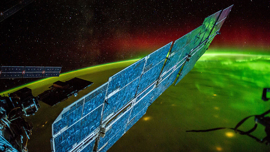 The International Space Station Flies Over an Aurora