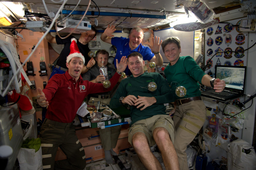 The Expedition 50 crew enjoys an international Christmas dinner aboard the space station. 