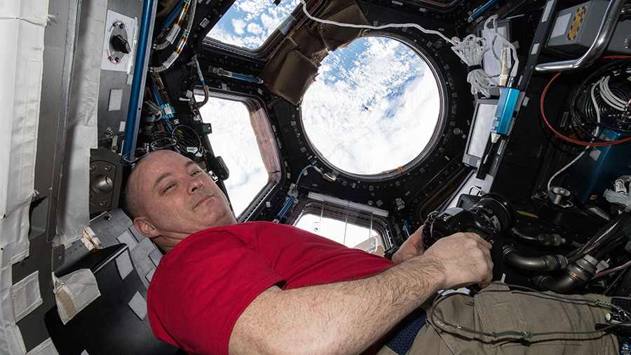 Astronaut Scott Tingle watches the SpaceX Dragon cargo craft arrive