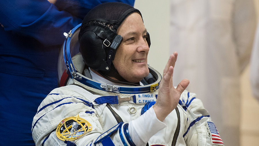 NASA astronaut Scott Tingle waves as he waits